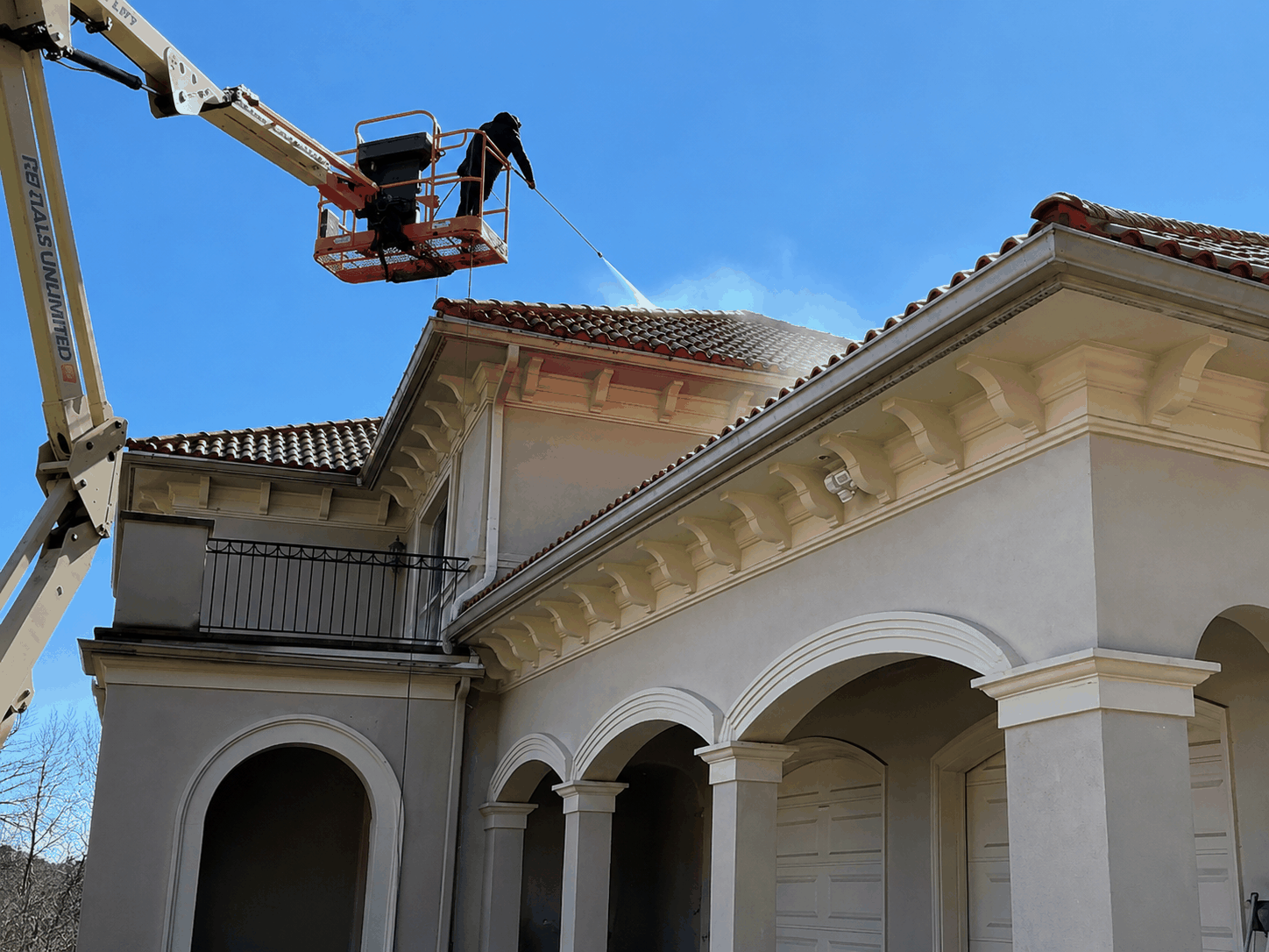 Professional property cleaning with an aerial lift